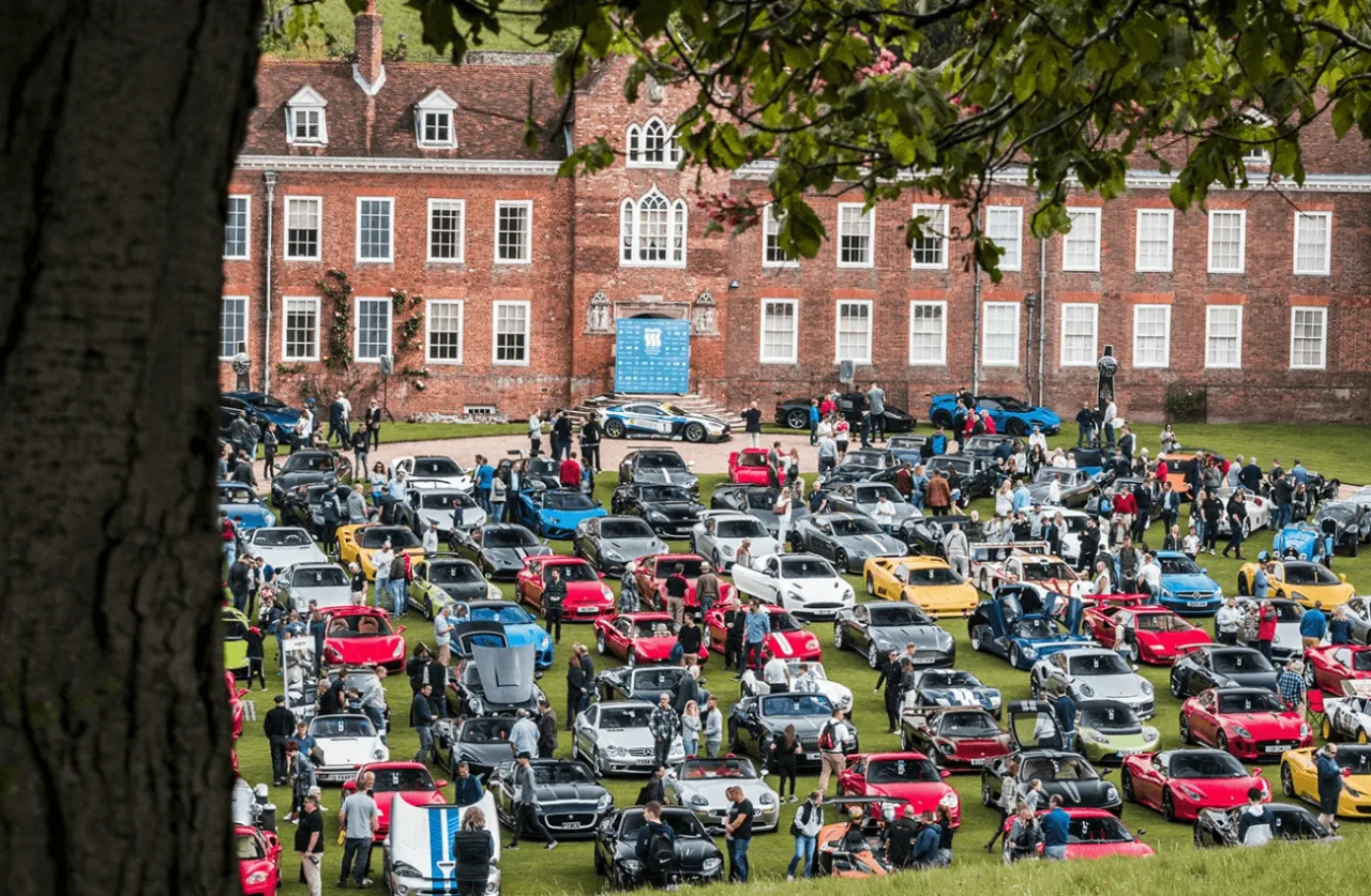 Sports and luxury cars lined up on the lawn in front of Stonor House during an event at the estate.