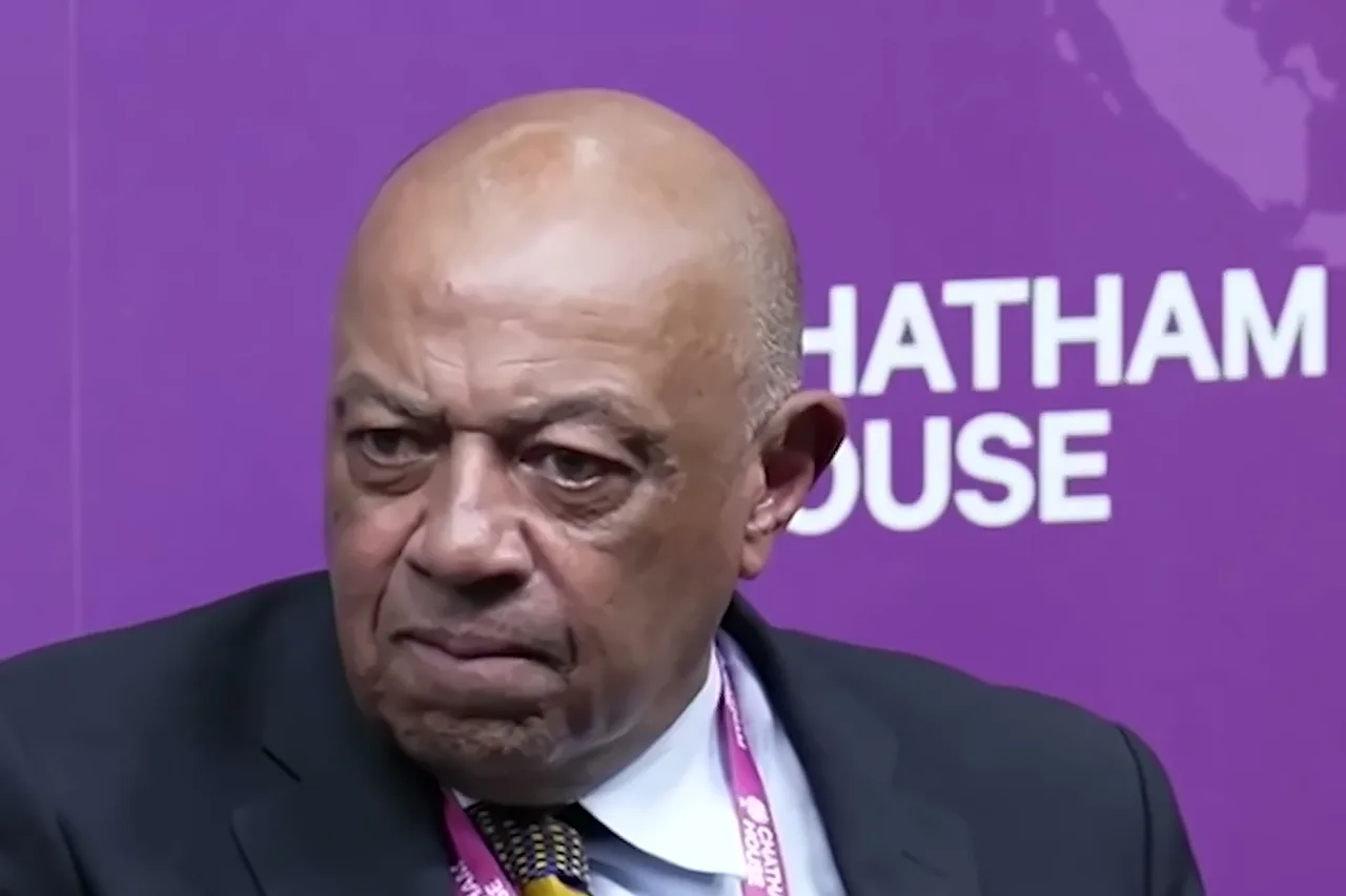 Lord Boateng speaking at Chatham House’s reparative justice event, in a dark suit with a lanyard, against a purple Chatham House backdrop.