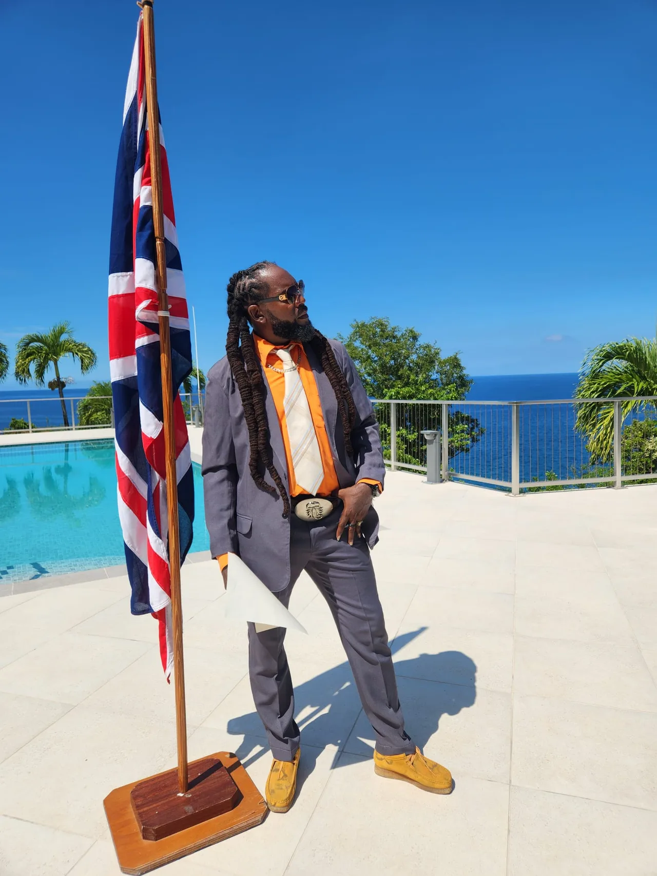 Vere Hendrickson beside the Union flag following his citizenship ceremony in Montserrat.